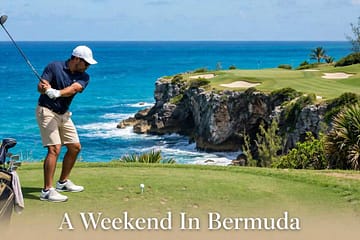Golfer teeing off on the cliffside 16th hole at Port Royal Golf Course in Bermuda.